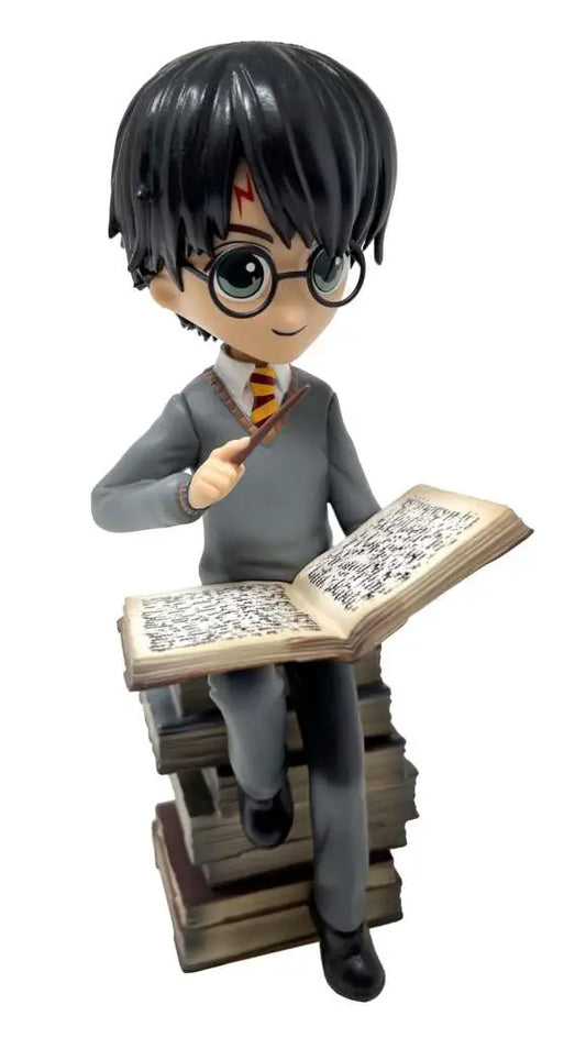 HP HARRY ON PILE OF SPELL BOOKS FIGURE
